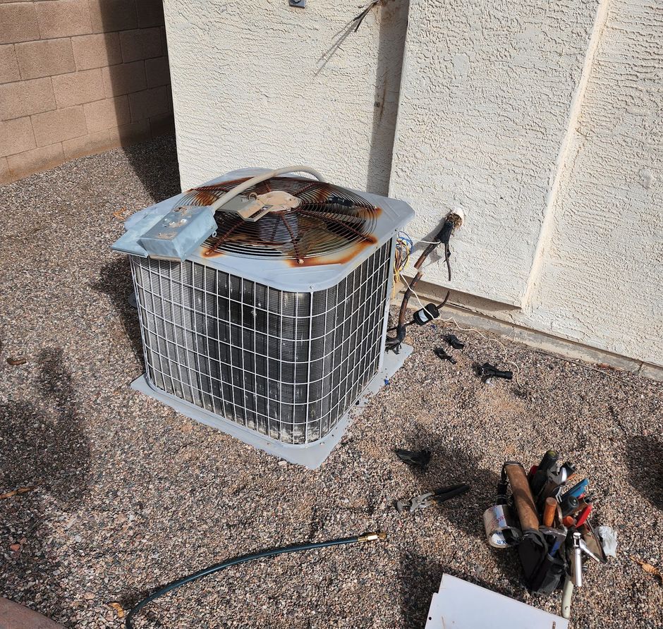 State Forty Eight technician's open air conditioning condenser with the top panel removed and tools laid out beside it
