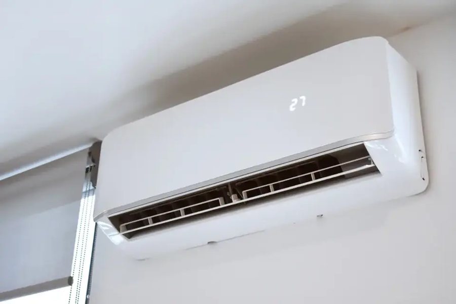 Ductless mini split head mounted on an interior wall