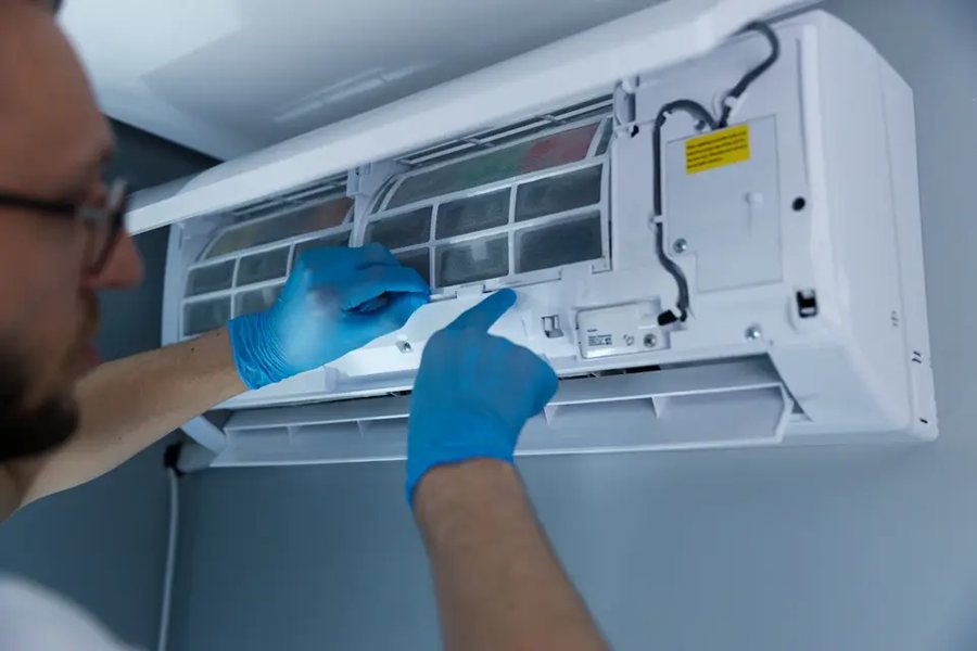 Technician servicing an indoor air handler